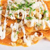 Chicken Chilaquiles · A handful of fried tortilla chips topped with powered cotija cheese, melted Monterey Jack ch...