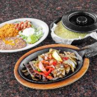 Fajitas · Chicken or beef fajitas with sauteed onions and peppers served with guacamole, pico de gallo...