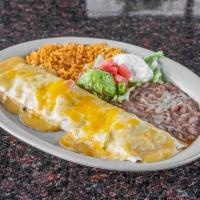 Burritos · Beef or chicken fajita topped with chili con carne or queso sauce served with guacamole , so...