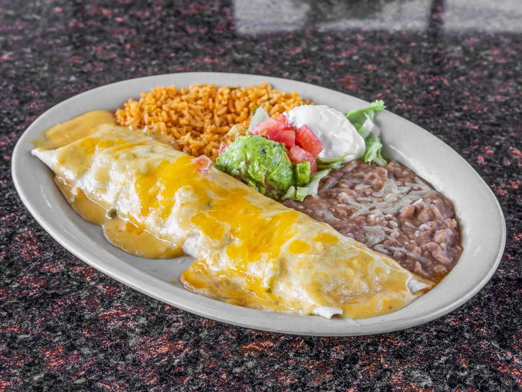 Burritos · Beef or chicken fajita topped with chili con carne or queso sauce served with guacamole , sour cream, rice and beans.