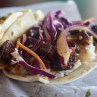  24. Pork Belly Taco  · Asian.  Pan seared sweet and spicy pork belly, rice, shredded cabbage, crushed red peppers a...