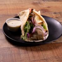 The Classic Gyro Wrap · Rotisserie style roasted lamb and beef wrapped in pita bread, topped with lettuce, tomatoes,...
