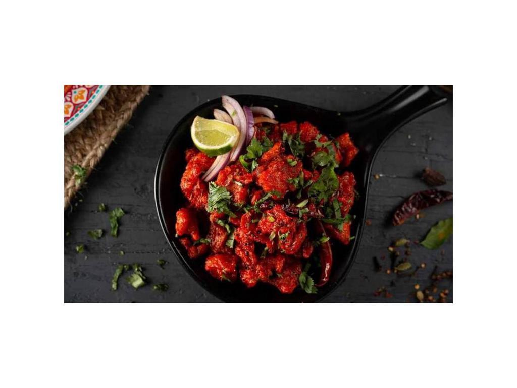 Chicken 65 · Boneless chicken pieces tossed with curry leaves, cumin seeds, green chili, and house special South Indian '65' sauce
