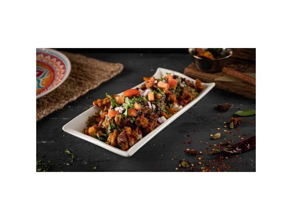 Paradise Chicken Chaat · Boneless chicken pieces lightly tossed in creamy Butter Sauce, topped with fresh channa, yogurt, diced onion, tomato, chili, cumin, and chutneys