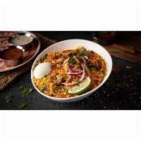 Goat Dum Biryani · Unique traditional-layered rice dish cooked with succulent goat meat, Basmati rice, and exot...