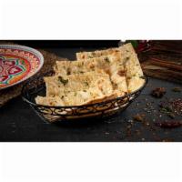 Garlic Naan · Fresh home-made white bread baked with minced garlic & cilantro in clay oven
