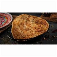 Paratha · Traditional flaky flatbread made with fresh layered wheat flour on tawa (flat-top)
