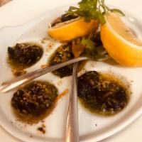 Escargot Bourguignonn · Marinated and served in a burgundy shallot herb butter.