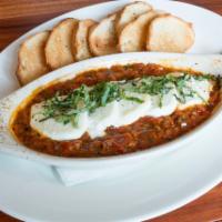 Baked Goat Cheese · Sliced goat cheese baked in our spicy arrabbiata sauce with fresh basil. Served with toasted...