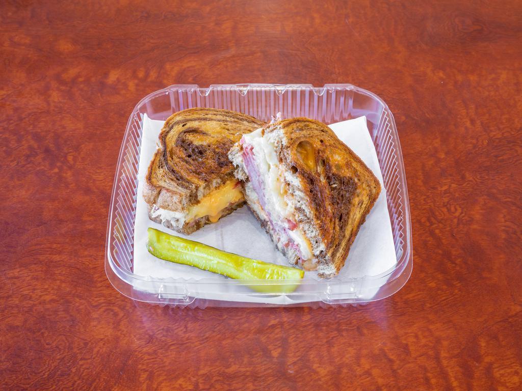 Reuben Sandwich · Grilled pastrami or turkey, Swiss cheese, coleslaw or sauerkraut, Thousand Island dressing on grilled marbled rye.