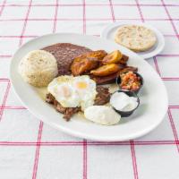 Desayuno Hondureno · Grilled steak carne asada, 2 eggs over easy, fried plantains, rice, beans, sour cream, chees...
