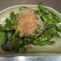 Sauteed Shishito Peppers · Sauteed shishito peppers marinated in sweet sake soy sauce with bonito flakes on top.