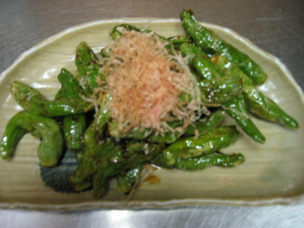 Sauteed Shishito Peppers · Sauteed shishito peppers marinated in sweet sake soy sauce with bonito flakes on top.