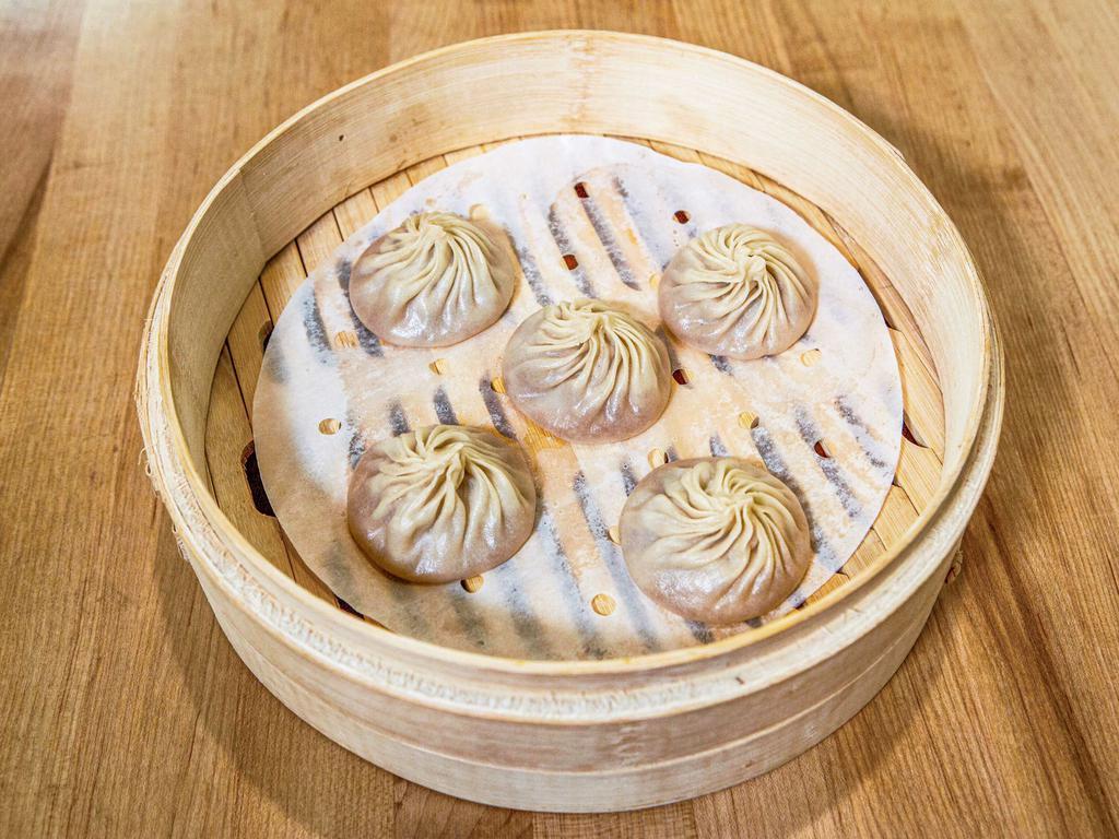 pork xiao long bao · five (5) pieces of pork xiao long bao.  served with ginger and vinegar
(handmade and delicately thin-skinned, these steamed 