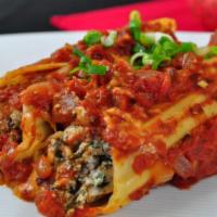 Baked Manicotti Pasta · 2 large pasta rolls filled with a blend of cheeses, baked, and smothered in homemade marinar...