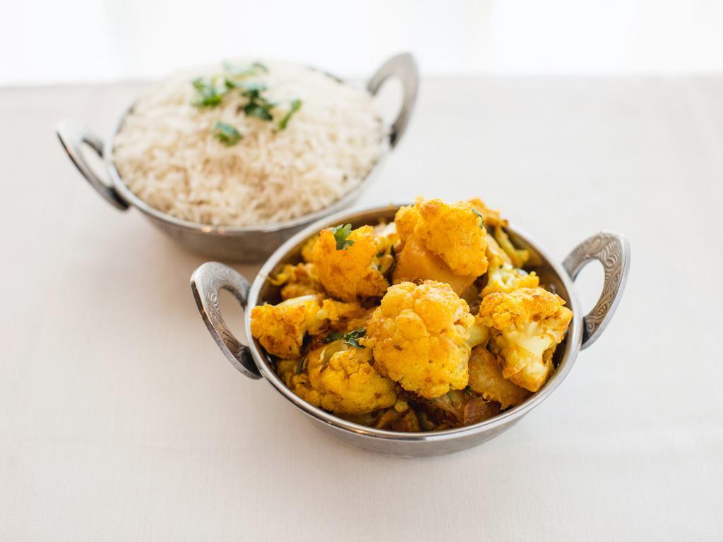 Aloo Gobhi · Cauliflower with potato cooked with ginger and herbs.