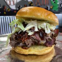 Shaved Brisket Sandwich · 1/3 lb. of smoked brisket on a bun served with 1 of our signature sauces. Add extras for an ...