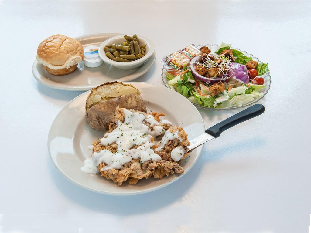 Chicken Fried Steak · A generous portion of hand breaded beef ladled with cream gravy. Served with vegetable, choice of potato, and choice of dinner salad or cup of soup.