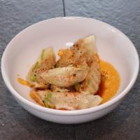 Spicy Gyoza  · Steamed pot stickers with spicy sauce