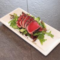 Seared Tuna Sashimi Salad · Five piece seared tuna served with our ginger ponzu sauce on a bed of green salad.