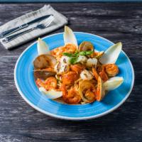 Thalassina Pasta · Sauteed seafood of clams, scallops, shrimp and lobster tail with light tomato sauce over you...