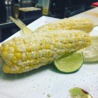 Elote Loco · A corn on the cob with a traditional Mexican mayonnaise, Cotija cheese and sprinkled with ch...