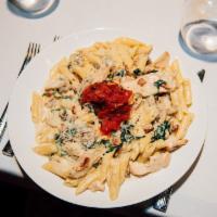 Pasta Con Pollo Dinner · Sauteed chicken and bacon tossed with spinach, mushrooms, penne pasta, fresh garlic in an As...
