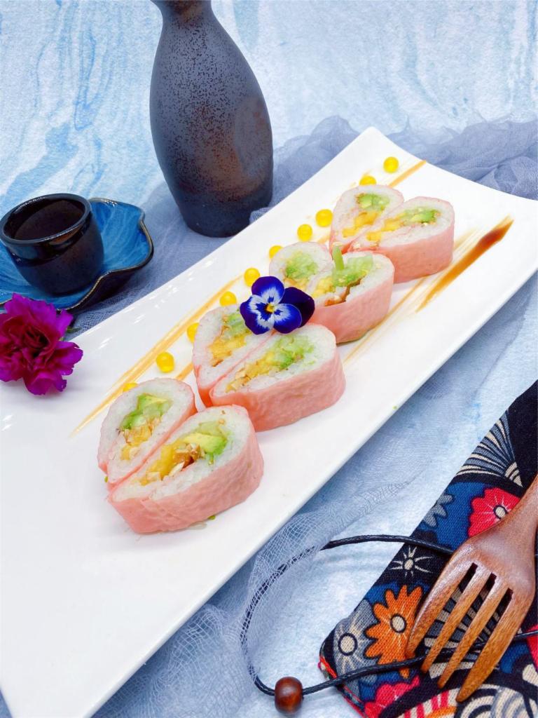 S12. Pink Lady Roll · Inside: cucumber, avocado, mango and peanut. Outside: mango sauce wrapped with soy paper (pink).