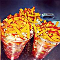 Crazy Churros · Cup filled with pickled pork rinds, diced cucumber, japanese peanuts, churritos(corn snack) ...