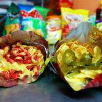 Dorinachos · Your choice of chips (prices vary) prepped with nacho cheese and your choice of different to...