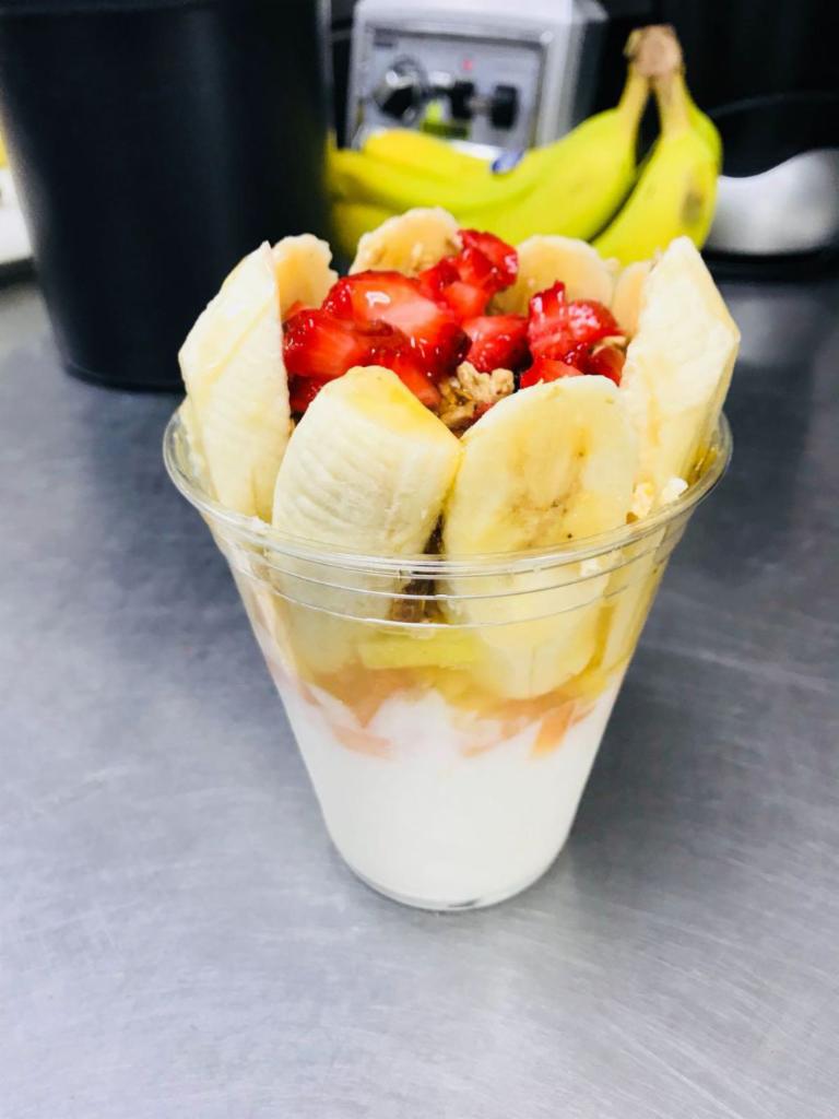 Yogurt with Fruit · Vanilla yogurt prepped with diced pineapple, diced cantaloupe, sliced banana, strawberry, granola with raisins and real honey.