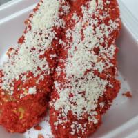Banderilla Hot cheeeto · Corn dog dip with nacho cheese and covered with hot cheeto with cotija cheese on top.

Bande...