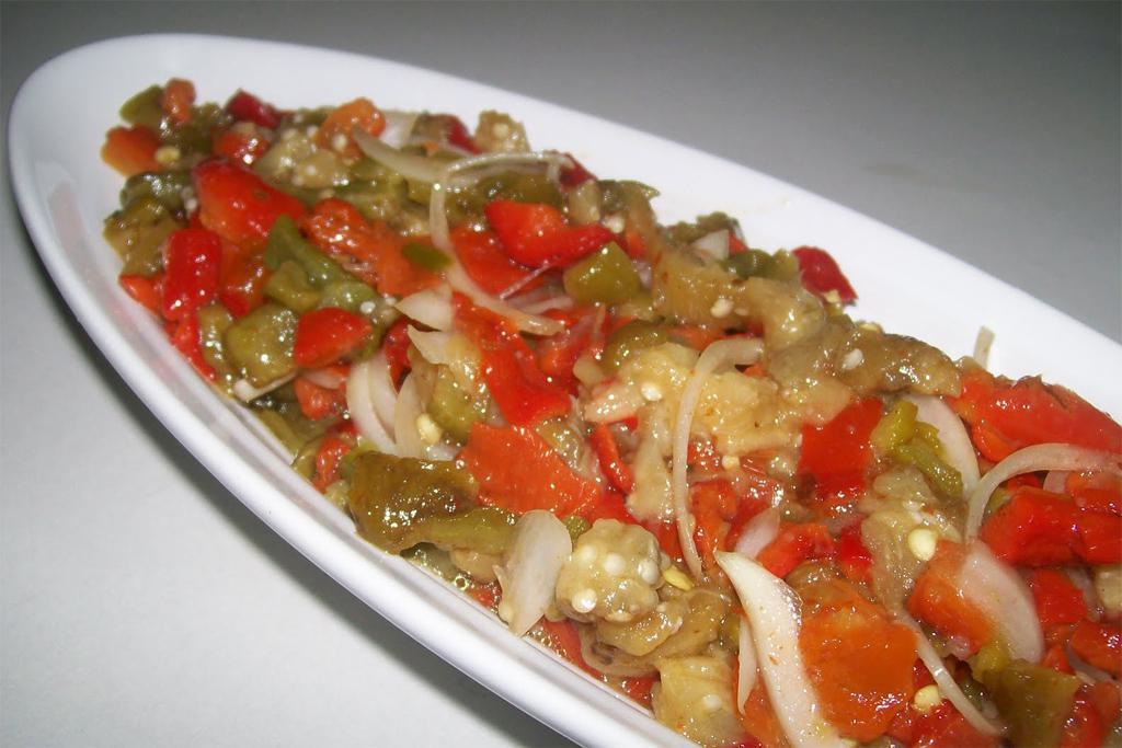 Eggplant Salad · Char-grilled smoked eggplant mixed with chopped red and green pepper, dill, garlic and olive oil.