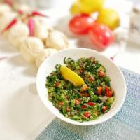 Tabbouleh · Cracked wheat mixed with green peppers, scallions, tomato and parsley.