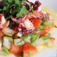 Grilled Portuguese Octopus · Grilled octopus marinated with olive oil, lemon juice and vinegar. Served with tomatoes and ...