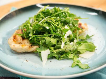 Chicken Paillard · Grilled chicken breast with arugula, tomato, red onion tossed with olive oil, vinegar and lemon juice. Garnished with Parmesan cheese.