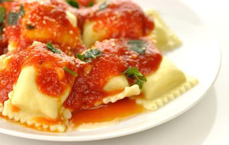 Cheese Ravioli · Ravioli topped with tomato sauce and melted mozzarella cheese. Served with garlic bread.
