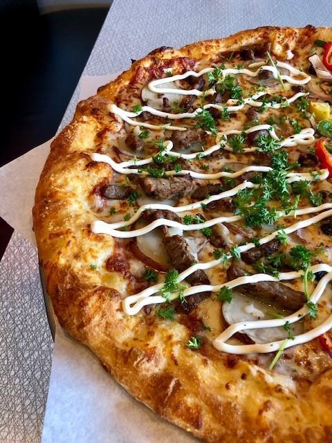 Steak and Potato Pizza · Marinated choice steak, baby red potatoes and a splash of sour cream.