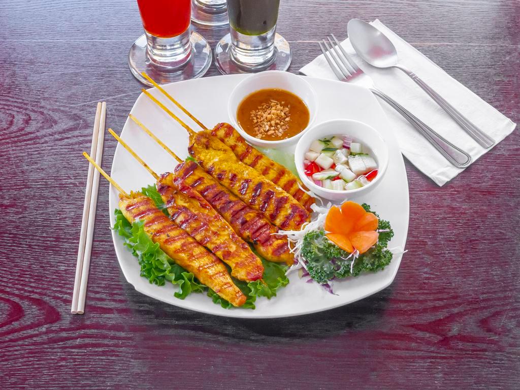 7. Satay Chicken · Sliced chicken marinated in Thai spices and grilled to perfection on bamboo skewers. Served with cucumber salad and peanut sauce.