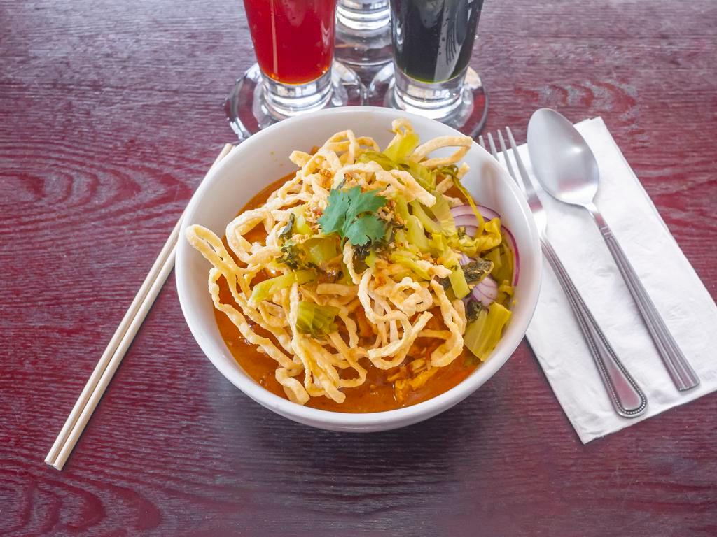 Khao Soi · Try our *NEW* Northern Thai style Curry Noodle Soup. Contains : Noodles, Pickled greens, Bean sprouts, red onion, Lime, topped with crispy noodles.