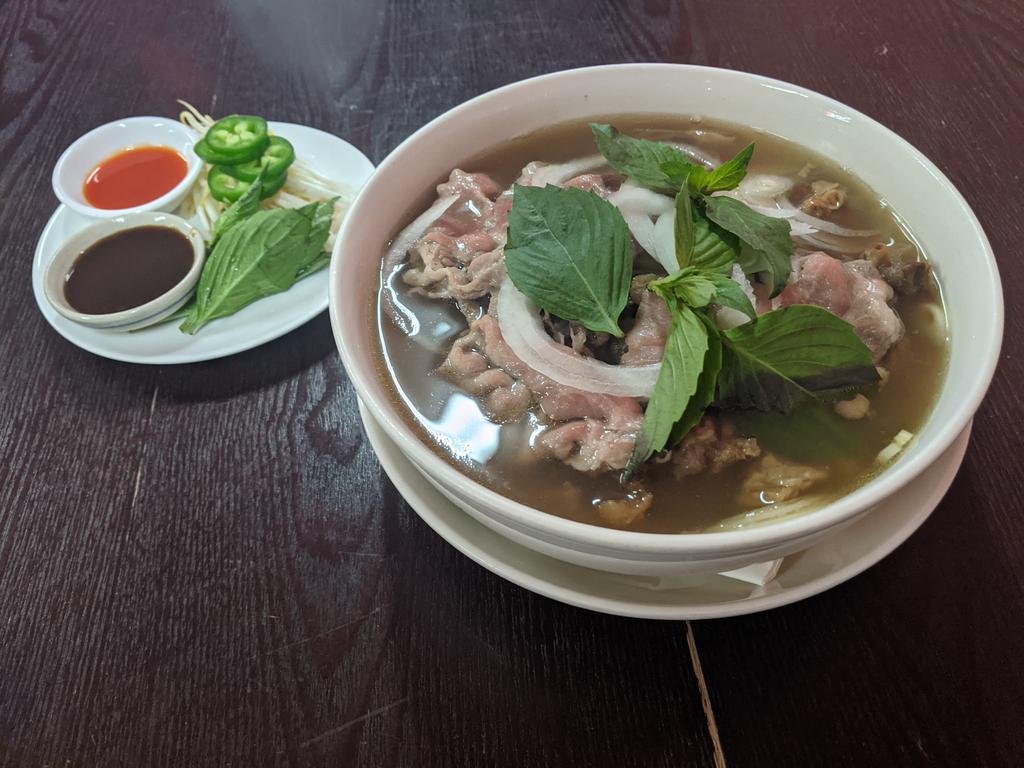 Pho  · Traditional Vietnamese noodle soup. Slow cooked bone broth with rice noodles, sliced beef, beef tendon, and beef meatballs. Served with bean sprouts, fresh basil, and jalapeno on the side.