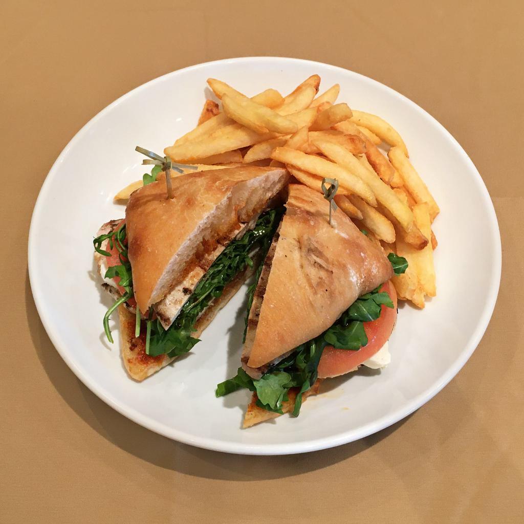 Grilled Chicken Sandwich · Grilled chicken breast, arugula, tomatoes and mozzarella cheese with homemade pesto sauce and balsamic glaze.
