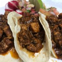 Chicharron Taco · Spicy red chile pork and pico de gallo.