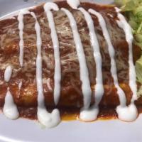 Chicken enchiladas (2) · Two chicken enchiladas topped with enchilada sauce, cheese, lettuce and sour cream.