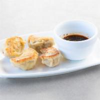 Peking Ravioli · 鍋貼  — Pork dumplings, with ginger dipping sauce. Can be made pan-fried or steamed. 