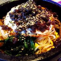Dol Sot Bibimbap · Variety of seasoned vegetables, egg and chopped beef over rice in a sizzling hot stone bowl....