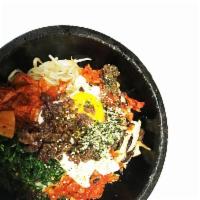 Kimchee Dol Sot Bibimbap · Stir-fried kimchee, variety of seasoned vegetables, egg and chopped beef over rice in a sizz...