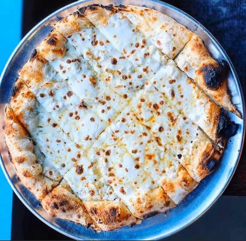 Extra Large Cheesy Bread · House wood-fired pizza dough topped with mozzarella cheese and baked to melty perfection.  Served with side of marinara sauce