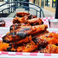 Bone In Wings · Bone-in wings fried crispy and char-grilled. Tossed in your choice of sauce