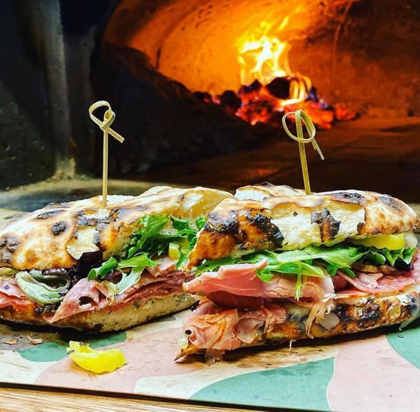 Goodfella Sandwich · Jon's Naturals ham, capicola, salami, mozzarella cheese, garlic mayo, lettuce, banana peppers, red onions and italian dressing served on wood-fired bread with your choice of side